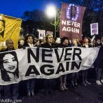 Colour photo of evening protest with banners of Savita Halappanavar and Never Again
