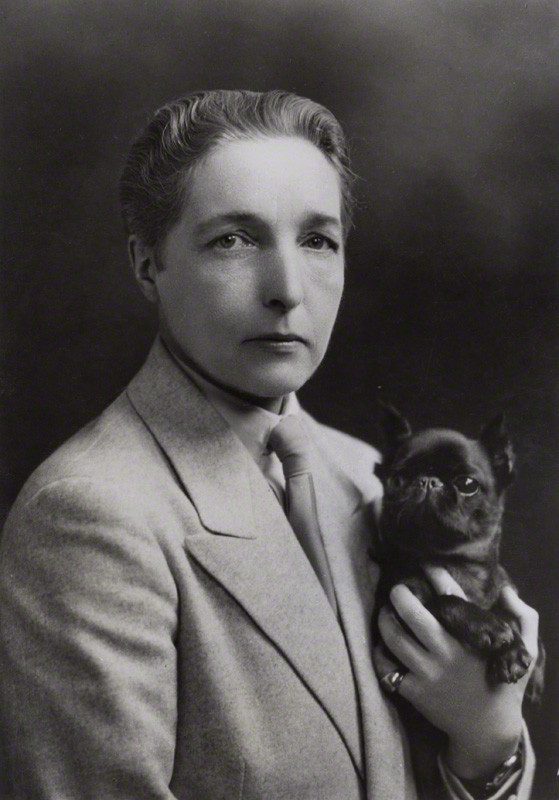 Black and white portrait photo of Radclyffe Hall and her dog